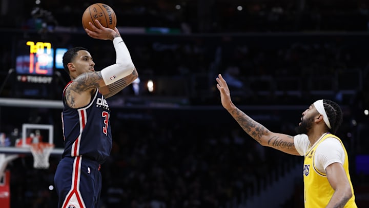 Apr 3, 2024; Washington, District of Columbia, USA; Washington Wizards forward Kyle Kuzma (33) shoots the ball as l3/ defends in the second half at Capital One Arena. Mandatory Credit: Geoff Burke-Imagn Images