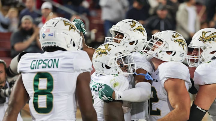 Sep 16, 2023; Stanford, California, USA; Sacramento State Hornets running back Marcus Fulcher (9) is congratulated by teammates after scoring a touchdown during the fourth quarter against the Stanford Cardinal at Stanford Stadium. Mandatory Credit: Sergio Estrada-Imagn Images