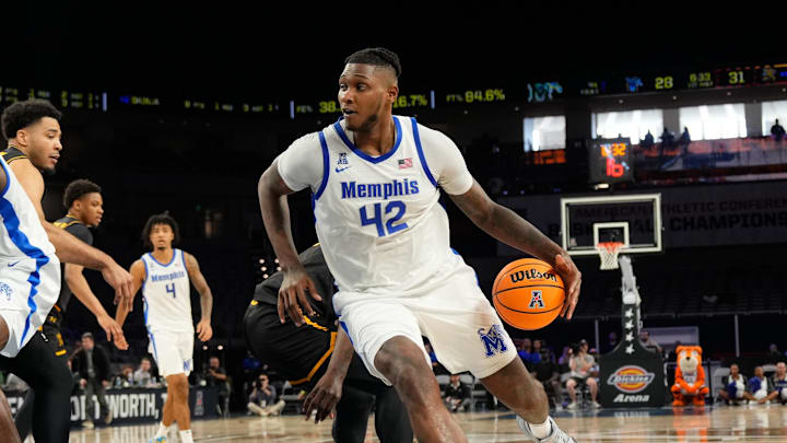 Mar 14, 2025; Fort Worth, TX, USA;  Memphis Tigers forward Dain Dainja (42) drives the basket ahead of Wichita State Shockers center Quincy Ballard (15) during the first half at Dickies Arena. Mandatory Credit: Chris Jones-Imagn Images