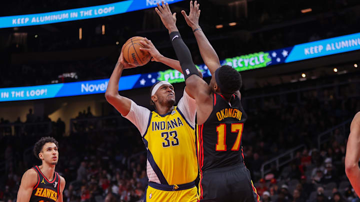 Mar 6, 2025; Atlanta, Georgia, USA; Indiana Pacers center Myles Turner (33) shoots past Atlanta Hawks forward Onyeka Okongwu (17) in the fourth quarter at State Farm Arena. Mandatory Credit: Brett Davis-Imagn Images