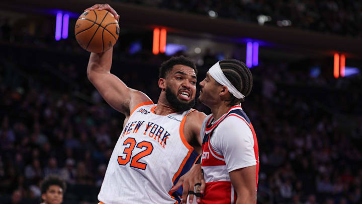 Mar 22, 2025; New York, New York, USA; New York Knicks center Karl-Anthony Towns (32) is fouled by Washington Wizards guard Jordan Poole (13) while rebounding during the second half at Madison Square Garden. Mandatory Credit: Vincent Carchietta-Imagn Images