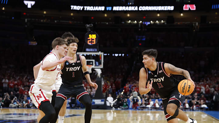 Mar 19, 2026; Oklahoma City, OK, USA; Troy Trojans forward Victor Valdes (11) drives to the hoop past Nebraska Cornhuskers forward Braden Frager (5) during the first half during a first round game of the men's 2026 NCAA Tournament at Paycom Center. Mandatory Credit: Alonzo Adams-Imagn Images