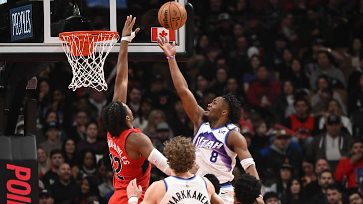 Feb 1, 2026; Toronto, Ontario, CAN;  Utah Jazz guard Isaiah Collier (8) shoots the ball as Toronto Raptors forward Collin Murray-Bowles (12) defends in the first half at Scotiabank Arena. Mandatory Credit: Dan Hamilton-Imagn Images