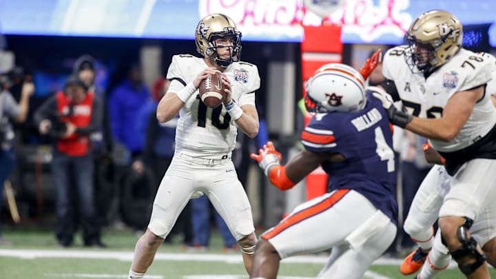 Jan 1, 2018; Atlanta, GA, USA; Central Florida Knights quarterback McKenzie Milton (10) drops back to pass against the Auburn Tigers in the first quarter in the 2018 Peach Bowl at Mercedes-Benz Stadium. Mandatory Credit: Brett Davis-Imagn Images