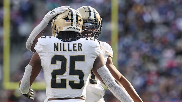 Dec 8, 2024; East Rutherford, New Jersey, USA; New Orleans Saints running back Kendre Miller (25) celebrates with running back Alvin Kamara (41) after a rushing touchdown during the first half against the New York Giants at MetLife Stadium. Mandatory Credit: Vincent Carchietta-Imagn Images