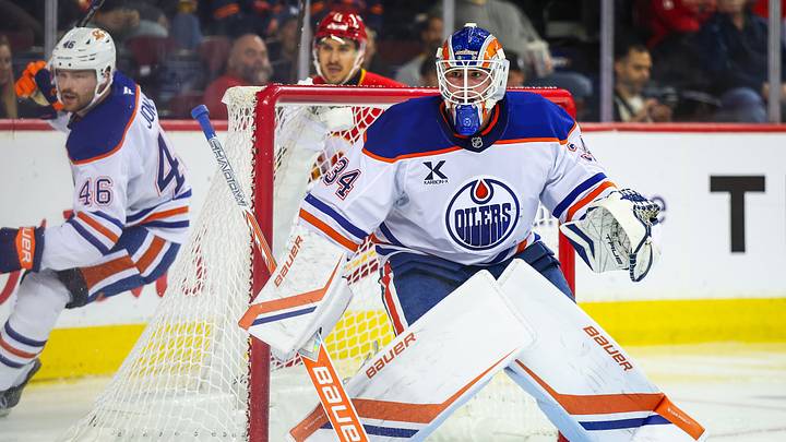 Sep 21, 2025; Calgary, Alberta, CAN; Edmonton Oilers goaltender Samuel Jonsson (34) guards his net against the Calgary Flames during the second period at Scotiabank Saddledome. Mandatory Credit: Sergei Belski-Imagn Images