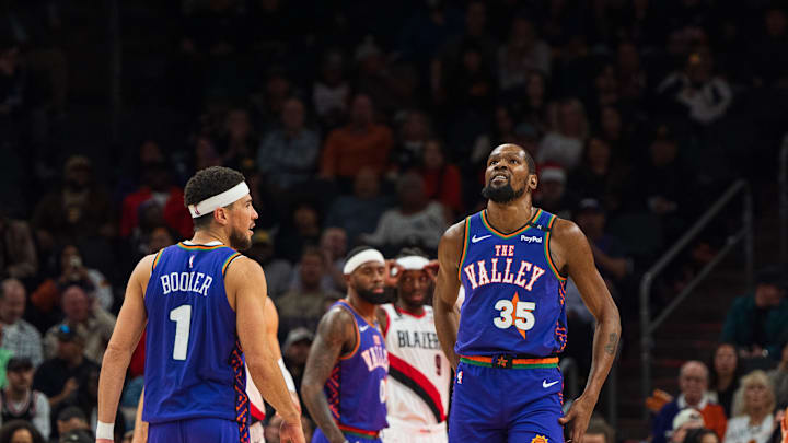 Dec 15, 2024; Phoenix, Arizona, USA; Phoenix Suns guard Devin Booker (1) and forward Kevin Durant (35) react between plays in the second half during a game against the Portland Trail Blazers at Footprint Center. Mandatory Credit: Allan Henry-Imagn Images Dec 15, 2024; Phoenix, Arizona, USA; Phoenix Suns guard Devin Booker (1) and forward Kevin Durant (35) react between plays in the second half during a game against the Portland Trail Blazers at Footprint Center. Mandatory Credit: Allan Henry-Imagn Images