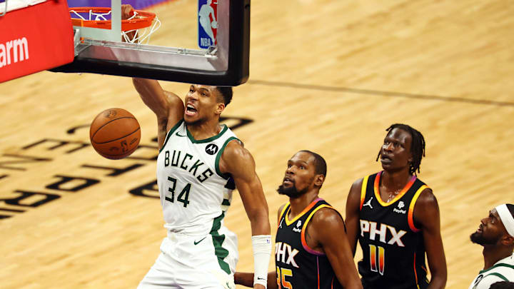 Feb 6, 2024; Phoenix, Arizona, USA; Milwaukee Bucks forward Giannis Antetokounmpo (34) dunks the ball against Phoenix Suns forward Kevin Durant (35) and center Bol Bol (11) during the fourth quarter Suns at Footprint Center. Mandatory Credit: Mark J. Rebilas-Imagn Images
