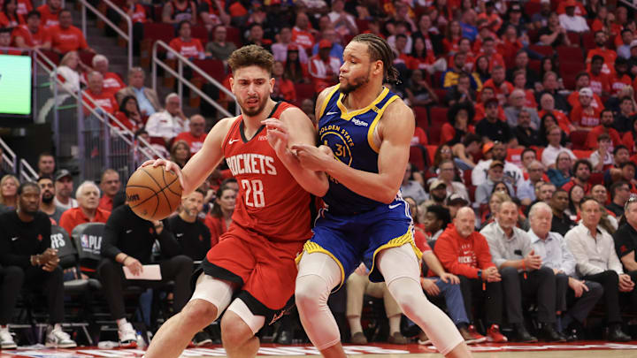 Apr 30, 2025; Houston, Texas, USA; Houston Rockets center Alperen Sengun (28) dribbles against Golden State Warriors forward Kevin Knox II (31) in the fourth quarter during game five of first round for the 2025 NBA Playoffs at Toyota Center. Mandatory Credit: Thomas Shea-Imagn Images