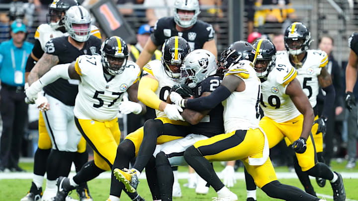 Oct 13, 2024; Paradise, Nevada, USA; Las Vegas Raiders running back Alexander Mattison (22) is stopped for a loss by the Pittsburgh Steelers linebacker T.J. Watt (90) and Pittsburgh Steelers linebacker Patrick Queen (6) during the second quarter at Allegiant Stadium. Mandatory Credit: Stephen R. Sylvanie-Imagn Images