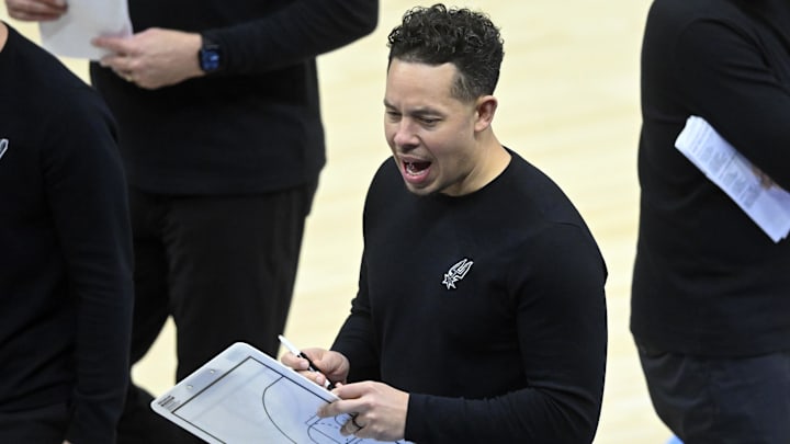 Mar 27, 2025; Cleveland, Ohio, USA; San Antonio Spurs assistant coach Mitch Johnson walks on the court during a timeout in the third quarter against the Cleveland Cavaliers at Rocket Arena. Mandatory Credit: David Richard-Imagn Images