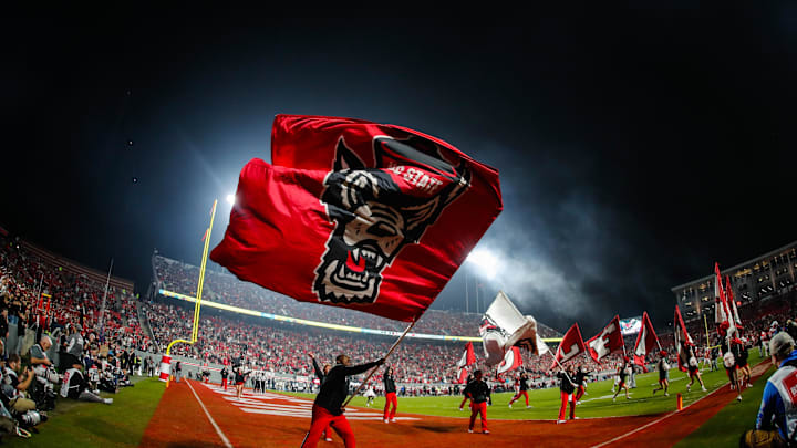 Nov 21, 2025; Raleigh, North Carolina, USA;  NC State Wolfpack cheerleader celebrates a touchdown during the second half of the game against Florida State Seminoles at Carter-Finley Stadium. Mandatory Credit: Jaylynn Nash-Imagn Images