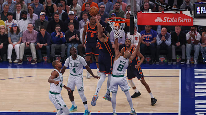 May 12, 2025; New York, New York, USA; New York Knicks center Karl-Anthony Towns (32) goes to the basket against Boston Celtics guard Derrick White (9) in the first half during game four of the second round for the 2025 NBA Playoffs at Madison Square Garden. Mandatory Credit: Vincent Carchietta-Imagn Images