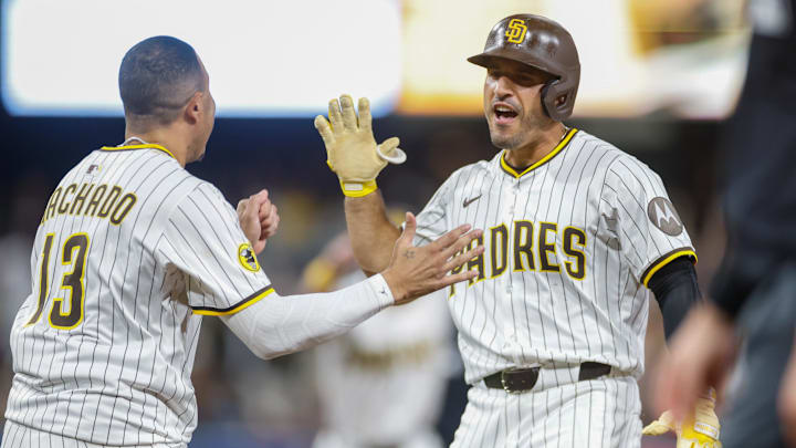 Aug 9, 2025; San Diego, California, USA; San Diego Padres left fielder Ramon Laureano (5) celebrates with third baseman Manny Machado (13) after hitting a walk-off single during the tenth inning against the Boston Red Sox at Petco Park. Mandatory Credit: David Frerker-Imagn Images