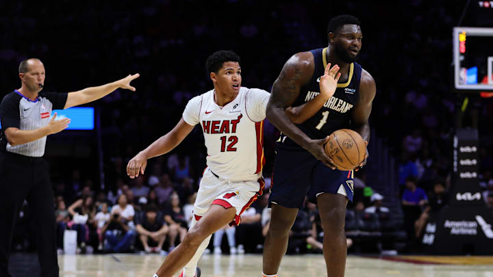 Oct 13, 2024; Miami, Florida, USA; Miami Heat guard Dru Smith (12) steals the ball from New Orleans Pelicans forward Zion Williamson (1) during the second quarter at Kaseya Center. Mandatory Credit: Sam Navarro-Imagn Images