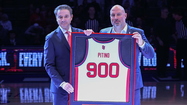 Jan 28, 2026; New York, New York, USA;  St. John's basketball head coach Rick Pitino is presented with a jersey for his 900th career win by Director of Athletics Ed Kull at Madison Square Garden. 