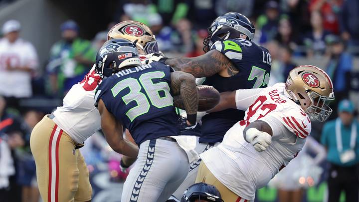 Oct 11, 2026; Seattle, Washington, USA;  San Francisco 49ers defensive tackle Gracen Halton (93) forces a fumble against Seattle Seahawks running back George Holani (36) during the first half at Lumen Field.  Mandatory Credit: Joe Nicholson-Imagn Images