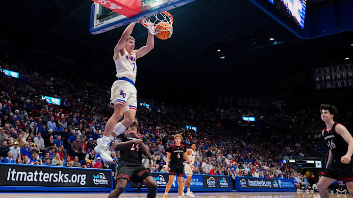 Dec 22, 2025; Lawrence, Kansas, USA; Kansas Jayhawks guard Kohl Rosario (7) dunks the ball as Davidson Wildcats forward JaQualon Roberts (24) defends during the second half of the game at Allen Fieldhouse. Mandatory Credit: Denny Medley-Imagn Images Dec 22, 2025; Lawrence, Kansas, USA; Kansas Jayhawks guard Kohl Rosario (7) dunks the ball as Davidson Wildcats forward JaQualon Roberts (24) defends during the second half of the game at Allen Fieldhouse. Mandatory Credit: Denny Medley-Imagn Images