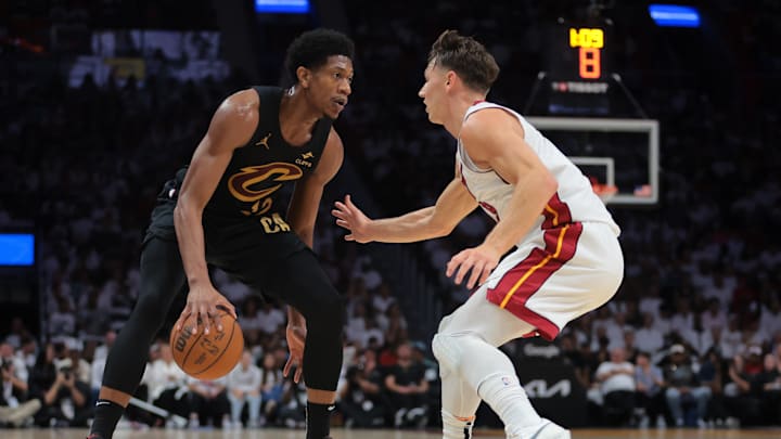 Apr 28, 2025; Miami, Florida, USA; Cleveland Cavaliers forward De'Andre Hunter (12) dribbles the basketball as Miami Heat guard Pelle Larsson (9) defends in the second quarter during game four for the first round of the 2025 NBA Playoffs at Kaseya Center. Mandatory Credit: Sam Navarro-Imagn Images