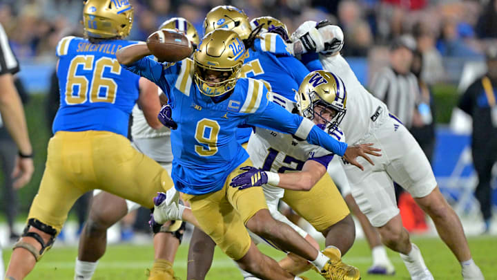 Nov 22, 2025; Pasadena, California, USA;  UCLA Bruins quarterback Nico Iamaleava (9) breaks away from Washington Huskies safety Alex McLaughlin (12) during the first half at the Rose Bowl. Mandatory Credit: Jayne Kamin-Oncea-Imagn Images