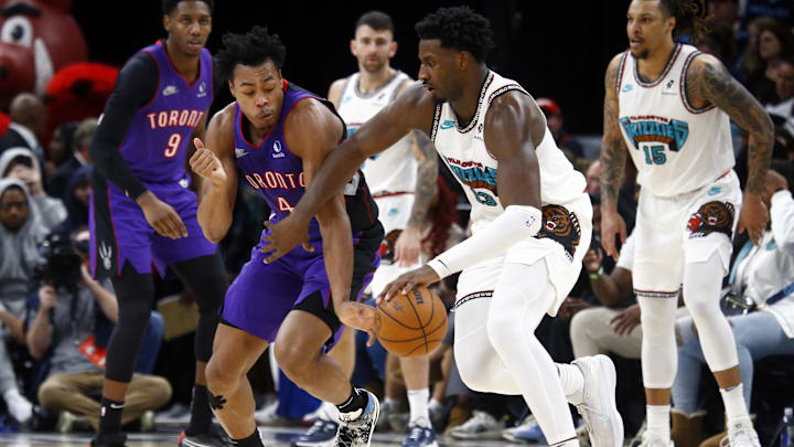 Dec 26, 2024; Memphis, Tennessee, USA; Memphis Grizzlies forward Jaren Jackson Jr. (13) dribbles as Toronto Raptors forward Scottie Barnes (4) defends during the fourth quarter at FedExForum. Mandatory Credit: Petre Thomas-Imagn Images