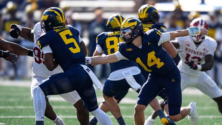 Michigan quarterback Tommy Carr (14) hands the ball to running back Savion Hiter (5) against Indiana during the second half at Michigan Stadium in Ann Arbor on Saturday, Oct. 24, 2026. Michigan quarterback Tommy Carr (14) hands the ball to running back Savion Hiter (5) against Indiana during the second half at Michigan Stadium in Ann Arbor on Saturday, Oct. 24, 2026.