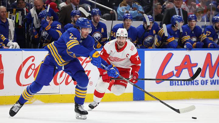Mar 27, 2026; Buffalo, New York, USA;  Detroit Red Wings center Dylan Larkin (71) looks to defend as Buffalo Sabres defenseman Owen Power (25) makes a pass during the first period at KeyBank Center. Mandatory Credit: Timothy T. Ludwig-Imagn Images