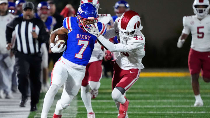 Owasso's Christian Collazo grabs the face mask off Bixby's Braeden Presley during the Class 6A-I state football championship game between Owasso and Bixby at Chad Richison Stadium in Edmond, Okla., Friday, Dec. 6, 2024.