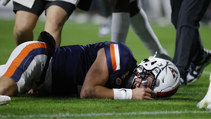 Nov 8, 2025; Charlottesville, Virginia, USA; Virginia Cavaliers quarterback Chandler Morris (4) lays on the field after being injected against the Wake Forest Demon Deacons during the first half at Scott Stadium. Mandatory Credit: Amber Searls-Imagn Images