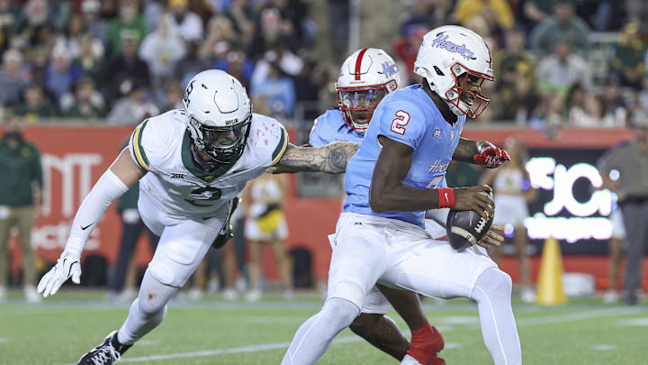 Nov 23, 2024; Houston, Texas, USA; Houston Cougars quarterback Zeon Chriss (2) runs with the ball as Baylor Bears linebacker Matt Jones (2) attempts to make a tackle during the third quarter at TDECU Stadium. Mandatory Credit: Troy Taormina-Imagn Images Nov 23, 2024; Houston, Texas, USA; Houston Cougars quarterback Zeon Chriss (2) runs with the ball as Baylor Bears linebacker Matt Jones (2) attempts to make a tackle during the third quarter at TDECU Stadium. Mandatory Credit: Troy Taormina-Imagn Images