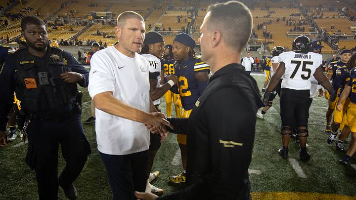 Cal coach Tosh Lupoi (left) greets Wake Forest's Jake Dickert after Saturday night's game. Cal coach Tosh Lupoi (left) greets Wake Forest's Jake Dickert after Saturday night's game.