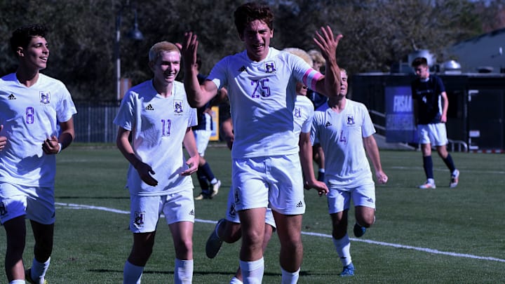Timber Creek senior defender Grayson Wright (25) celebrates after his 25-yard header tied the Class 7A boys soccer state semifinal against Palm Harbor on Monday at Lake Myrtle Sports Complex. 
