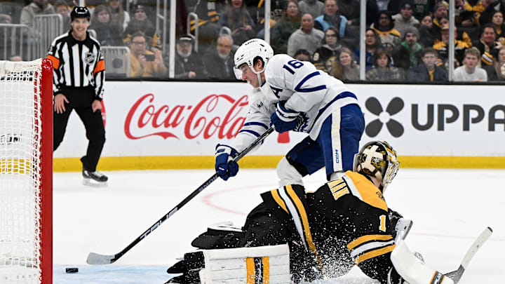 Feb 25, 2025; Boston, Massachusetts, USA; Toronto Maple Leafs right wing Mitch Marner (16) scores a goal on Boston Bruins goaltender Jeremy Swayman (1) during an overtime period at the TD Garden. Mandatory Credit: Brian Fluharty-Imagn Images