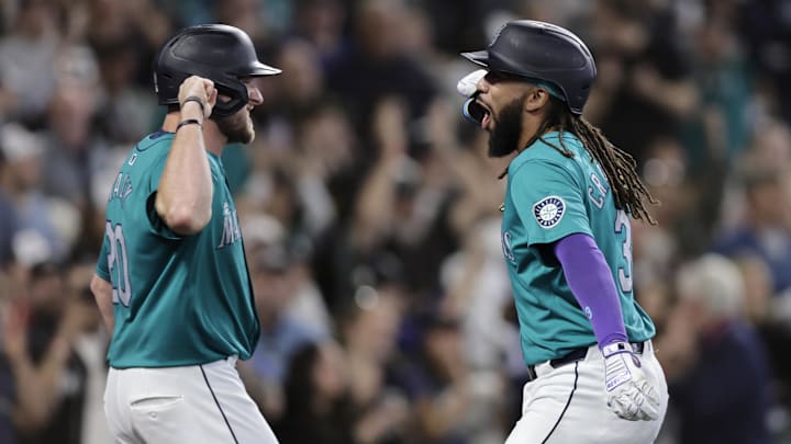 Jun 1, 2024; Seattle, Washington, USA;  Seattle Mariners shortstop J.P. Crawford, right, reacts with Seattle Mariners left fielderer Luke Raley, left, after hitting a grand slam against the Los Angeles Angels during the fourth inning at T-Mobile Park. Mandatory Credit: John Froschauer-USA TODAY Sports