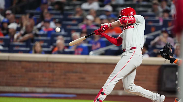 Sep 22, 2024; New York City, New York, USA;  Philadelphia Phillies third baseman Alec Bohm (28) hits an RBI single against the New York Mets during the first inning at Citi Field.