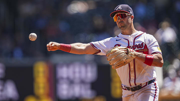 Aug 25, 2024; Cumberland, Georgia, USA; Atlanta Braves second baseman Whit Merrifield (15) throws out Washington Nationals center fielder Jacob Young (30) (not shown) after fielding a ground ball during the second inning at Truist Park. Mandatory Credit: Dale Zanine-Imagn Images