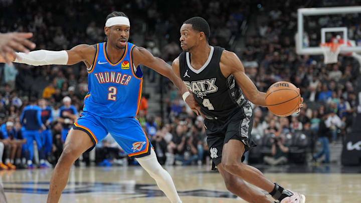 Mar 2, 2025; San Antonio, Texas, USA; San Antonio Spurs guard De'Aaron Fox (4) dribbles against Oklahoma City Thunder guard Shai Gilgeous-Alexander (2) in the first half at Frost Bank Center. Mandatory Credit: Daniel Dunn-Imagn Images Mar 2, 2025; San Antonio, Texas, USA; San Antonio Spurs guard De'Aaron Fox (4) dribbles against Oklahoma City Thunder guard Shai Gilgeous-Alexander (2) in the first half at Frost Bank Center. Mandatory Credit: Daniel Dunn-Imagn Images