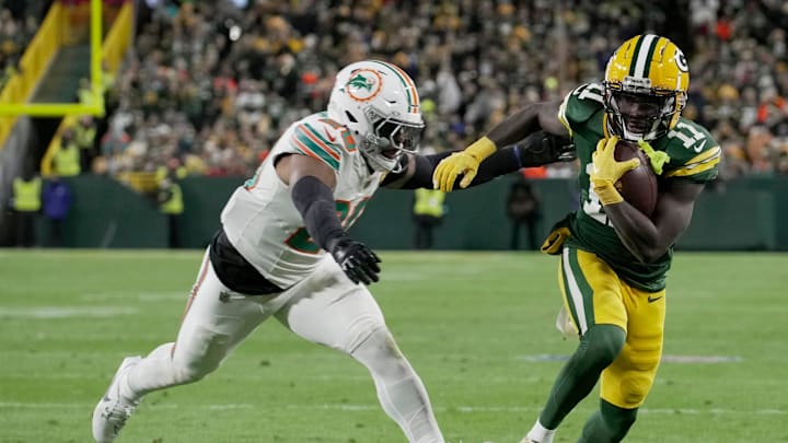 Green Bay Packers wide receiver Jayden Reed (11) outruns Miami Dolphins linebacker Jordyn Brooks (20) to score a touchdown on a reception during the second quarter of their game Thursday, November 28, 2024 at Lambeau Field in Green Bay, Wisconsin.