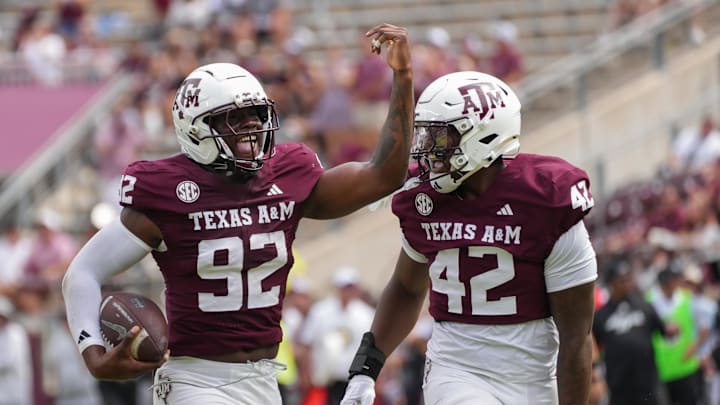 Sep 6, 2025; College Station, Texas, USA; Texas A&M Aggies defensive end Sam M'Pemba (92) and Texas A&M Aggies defensive end Kendall Jackson (42) celebrate after a recovered fumble during the second half against the Utah State Aggies at Kyle Field. Mandatory Credit: Sean Thomas-Imagn Images
