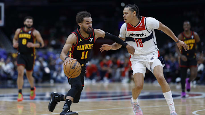 Oct 30, 2024; Washington, District of Columbia, USA; Atlanta Hawks guard Trae Young (11) drives to the basket as Washington Wizards forward Kyshawn George (18) defends in the first half at Capital One Arena. Mandatory Credit: Geoff Burke-Imagn Images