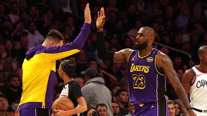Feb 28, 2025; Los Angeles, California, USA; Los Angeles Lakers forward LeBron James (23) celebrates with guard Luka Doncic (77) during the second quarter against the LA Clippers at Crypto.com Arena. Mandatory Credit: Jason Parkhurst-Imagn Images