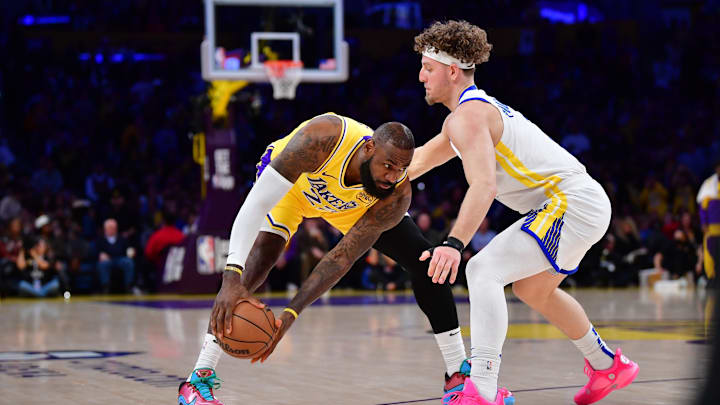 Apr 3, 2025; Los Angeles, California, USA;  Los Angeles Lakers forward LeBron James (23) moves the ball against Golden State Warriors guard Brandin Podziemski (2) during the first half at Crypto.com Arena. Mandatory Credit: Gary A. Vasquez-Imagn Images