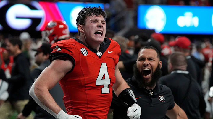 Georgia tight end Oscar Delp (4) celebrates after Georgia won in overtime of the SEC championship game against Texas in Atlanta, on Saturday, Dec. 7, 2024. Georgia won 22-19.