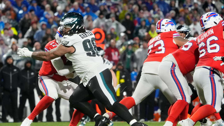 Dec 28, 2025; Orchard Park, New York, USA; Philadelphia Eagles defensive tackle Jalen Carter (98) sacks Buffalo Bills quarterback Josh Allen (17) during the second quarter at Highmark Stadium. 