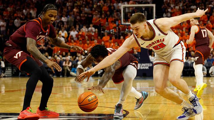 Mar 7, 2026; Charlottesville, Virginia, USA; Virginia Cavaliers forward Thijs de Ridder (28) and Virginia Tech Hokies forward Amani Hansberry (13) reach for a loose ball in the second half at John Paul Jones Arena. Mandatory Credit: Geoff Burke-Imagn Images
