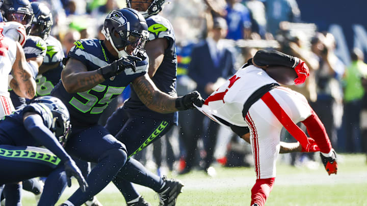 Oct 6, 2024; Seattle, Washington, USA; Seattle Seahawks defensive end Dre'Mont Jones (55) tackles New York Giants wide receiver Wan’Dale Robinson (17) following a reception by Robinson during the second quarter at Lumen Field. Mandatory Credit: Joe Nicholson-Imagn Images