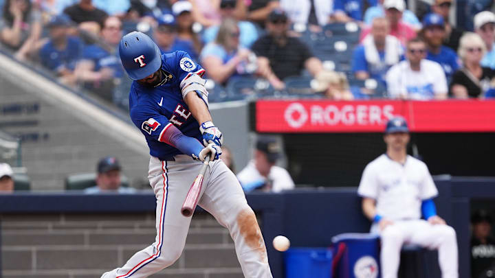 Aug 17, 2025; Toronto, Ontario, CAN; Texas Rangers second baseman Marcus Semien (2) hits a single against the Toronto Blue Jays during the seventh inning at Rogers Centre. 