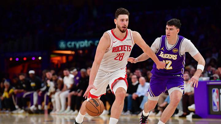 Apr 29, 2026; Los Angeles, California, USA; Houston Rockets center Alperen Sengun (28) moves the ball against Los Angeles Lakers forward Jake LaRavia (12) during the second half in game five of the first round of the 2026 NBA Playoffs at Crypto.com Arena. Mandatory Credit: Gary A. Vasquez-Imagn Images