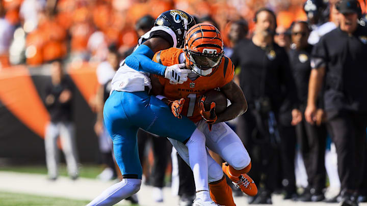 Sep 14, 2025; Cincinnati, Ohio, USA; Cincinnati Bengals wide receiver Ja'Marr Chase (1) runs with the ball against Jacksonville Jaguars defensive back Travis Hunter (12) in the second half at Paycor Stadium. Mandatory Credit: Katie Stratman-Imagn Images