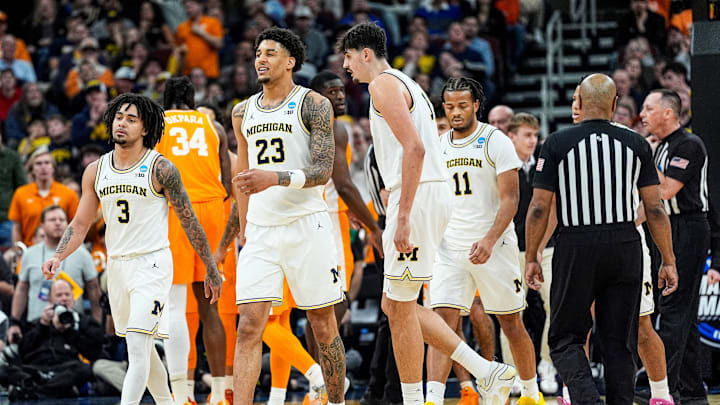 From left, Michigan guard Elliot Cadeau (3), forward Yaxel Lendeborg (23), center Aday Mara (15) walk off the court for a time against Tennessee during the second half of NCAA Tournament Elite 8 round at United Center in Chicago on Sunday, March 29, 2026.